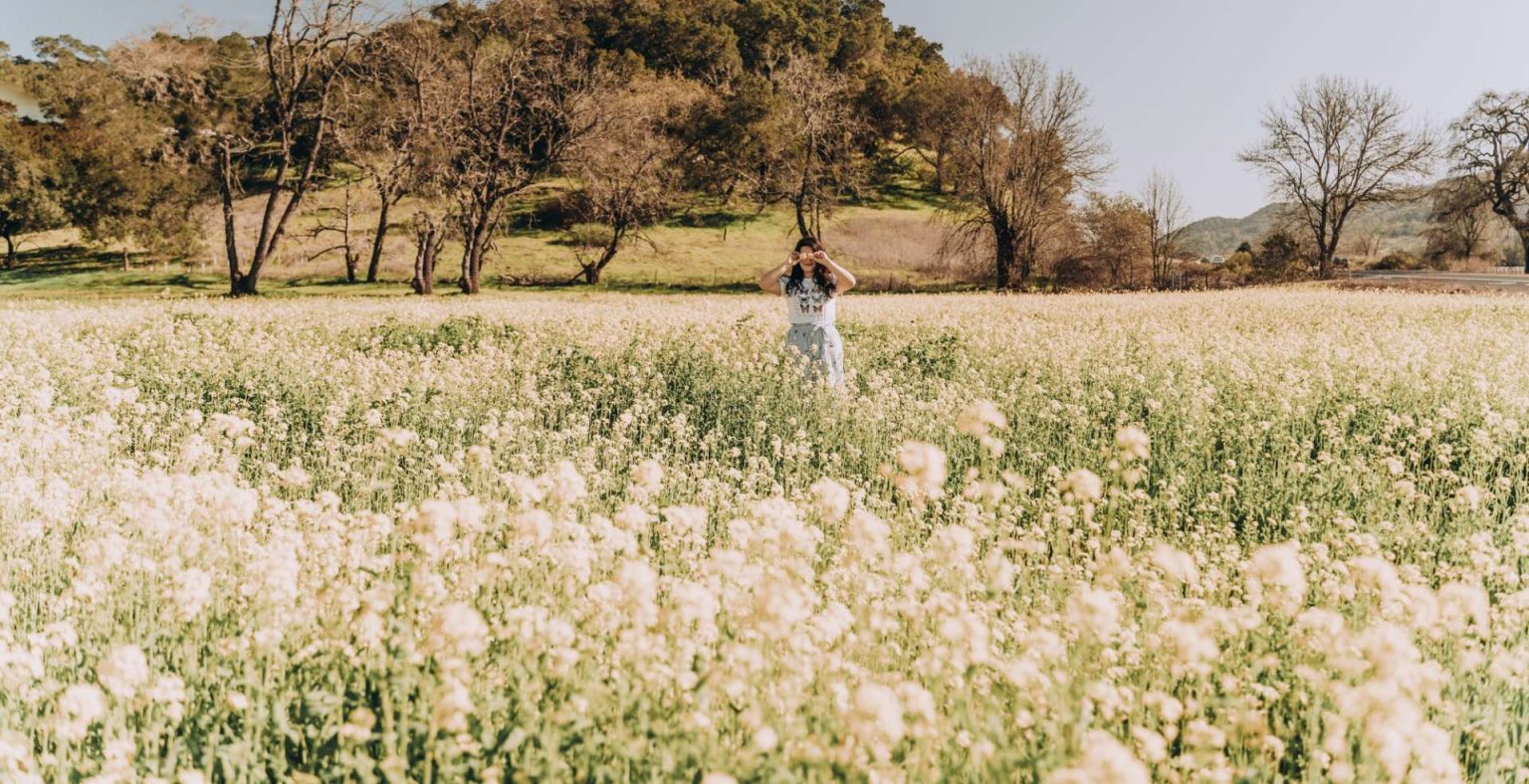 People in spring Happy Wanderlust woman in flower field feeling peaceful in springtime